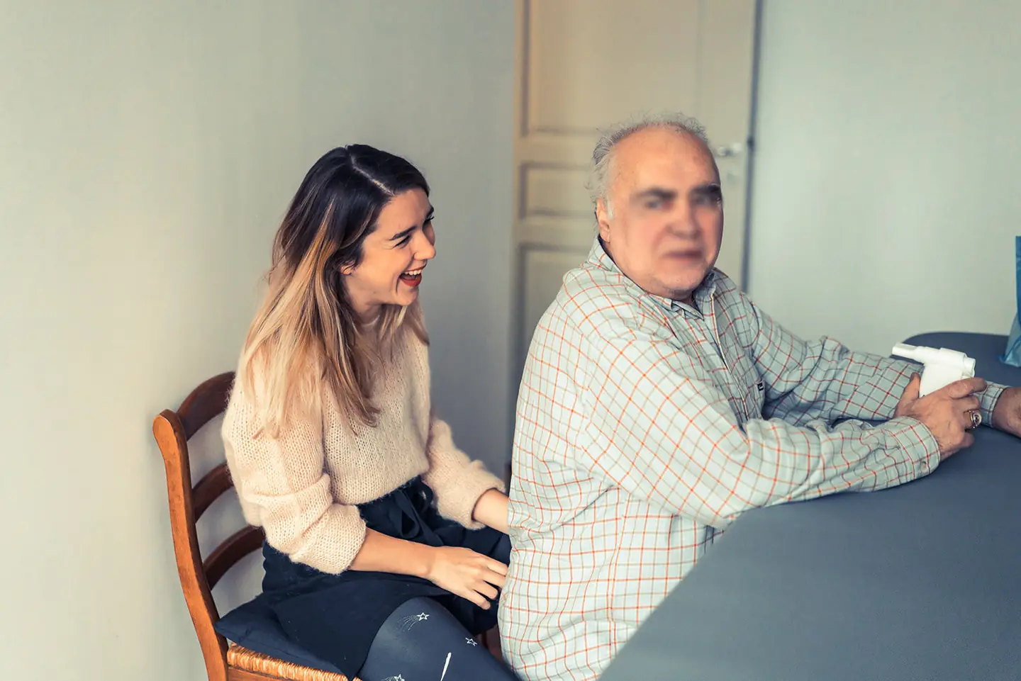 Un patient et une kinésithérapeute en consultation, autour d'une table